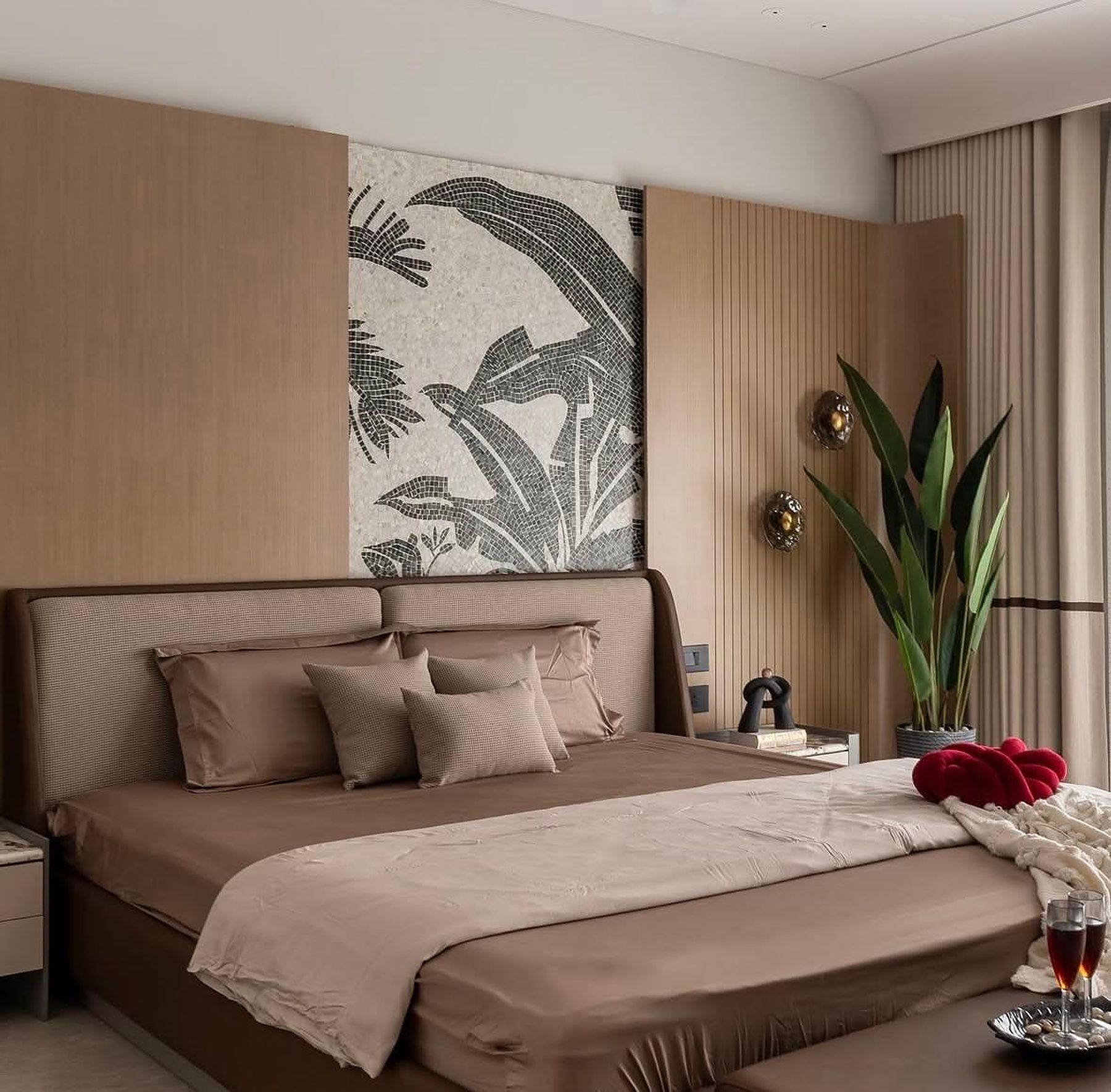 Bedroom with a black and white banana-leaf mosaic between oak wall panels